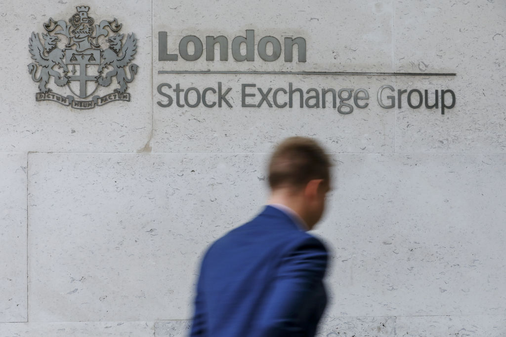 Man walks by London Stock Exchange Group logo