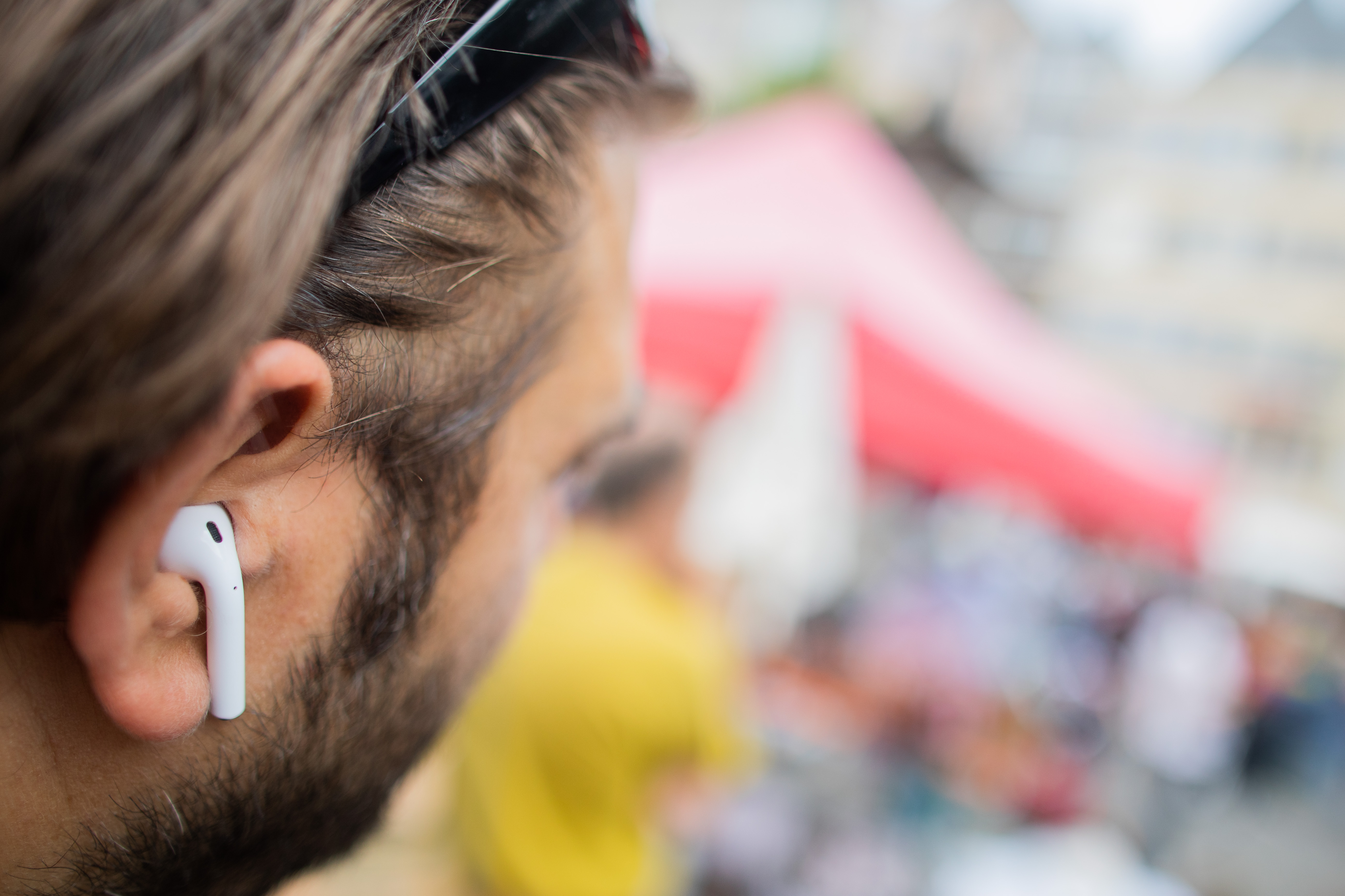 A man wears AirPods, Apple's wireless headphones