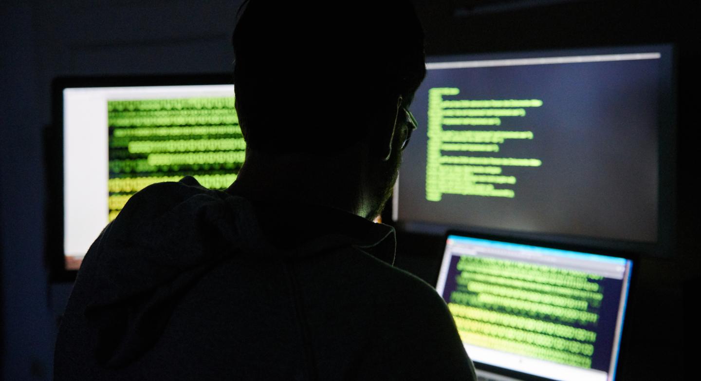 ILLUSTRATION - 16 July 2019, Berlin: A man sits in front of three screens with text.