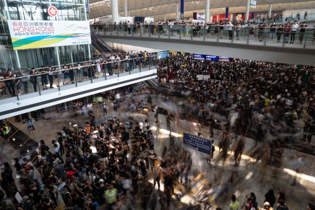 Protesters swarm the main terminal of Hong Kong International airport