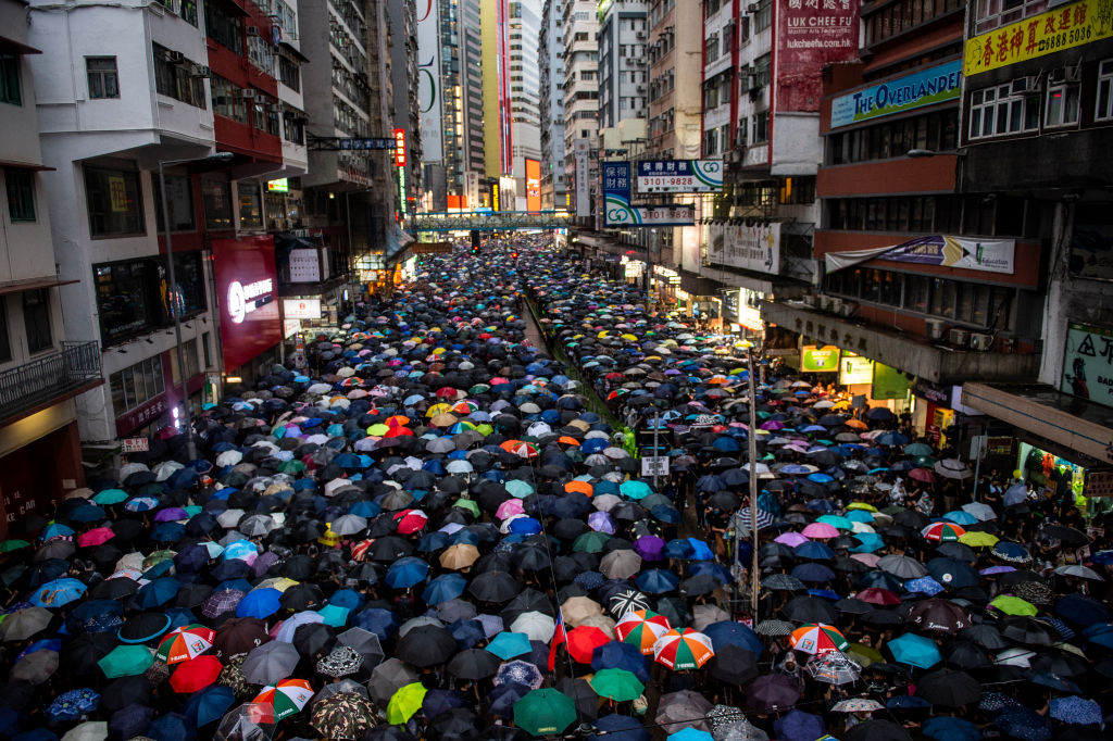 Hong Kong protesters march in the rain on Aug. 19