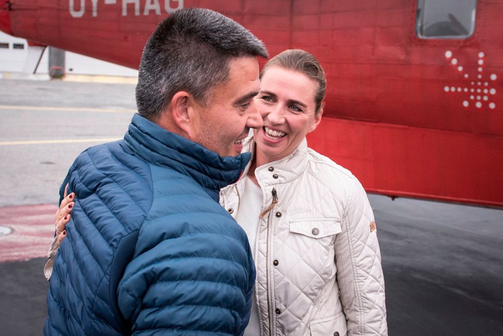 Danish Prime Minister Mette Frederiksen is greeted by Greenland's Premier and leader of the Siumut party Kim Kielsen, as she arrives for a two-day-visit in Nuuk in Greenland on August 18, 2109.