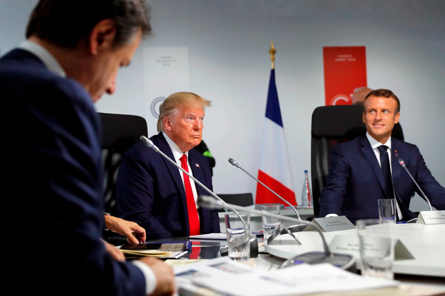 (From L) Italy's Prime Minister Giuseppe Conte, US President Donald Trump and France's President Emmanuel Macron attend a working session in Biarritz, south-west France on August 26, 2019, on the third day of the annual G7 Summit.