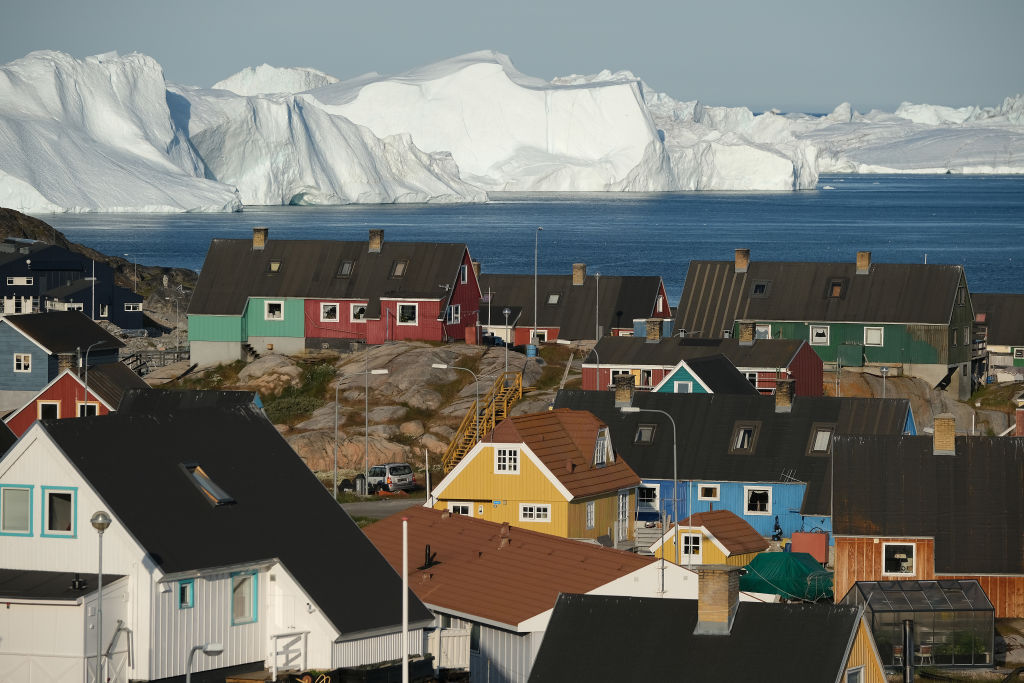 Icebergs floating behind the I;town center on July 30, 2019 in Ilulissat, Greenland. As the Earth's climate warms summers have become longer in Ilulissat, allowing fishermen a wider period to fish from boats on open waters and extending the summer tourist season. Long term benefits are uncertain, however, as warming waters could have a negative impact on the local fish and whale population. (Photo by Sean Gallup/Getty Images)