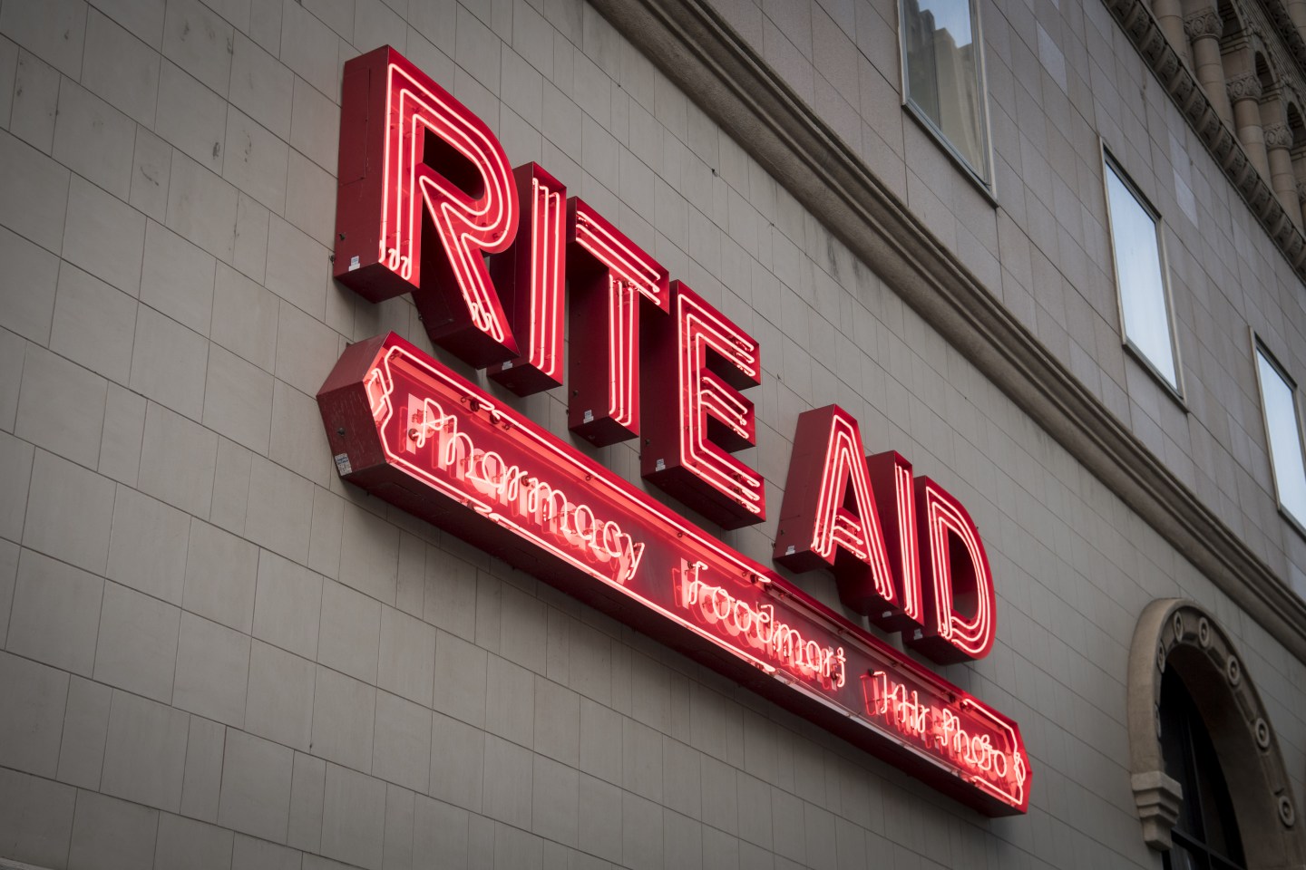 A red neon sign for the drug store Rite Aid