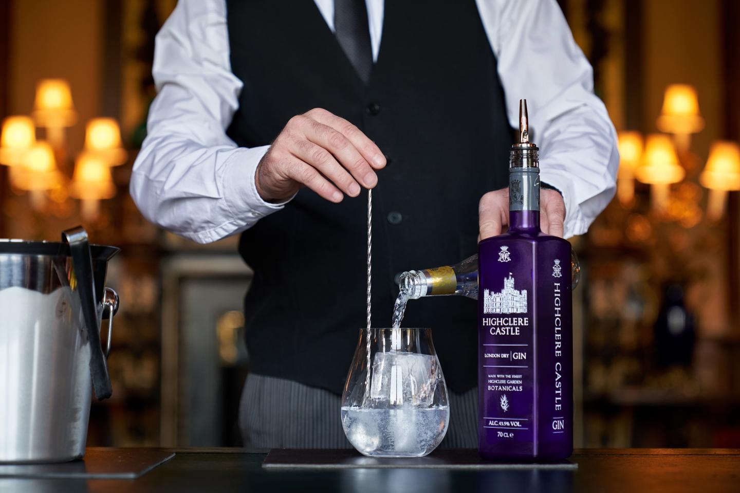 A bartender stirs a gin cocktail made with the new release from Highclere Castle Spirits.