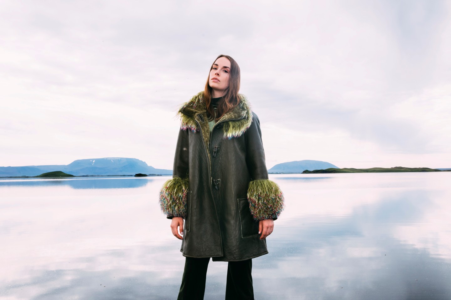 Co-founder and creative director Sophie Lundström Halbert models Therma Kōta's new Olavia reversible shearling in moss.