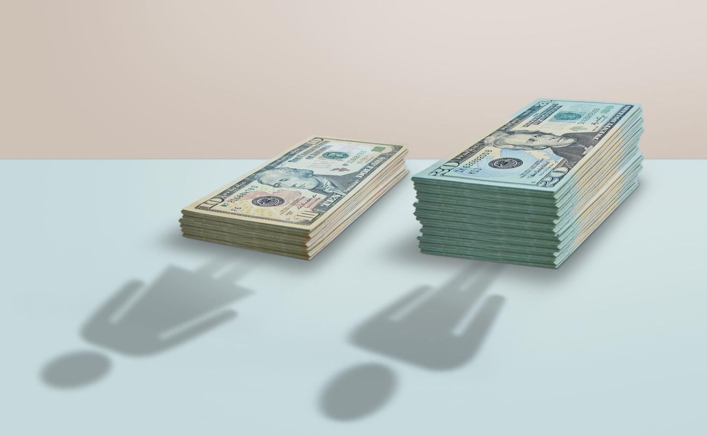 An illustration of the gender wage gap in U.S. dollar stacks.