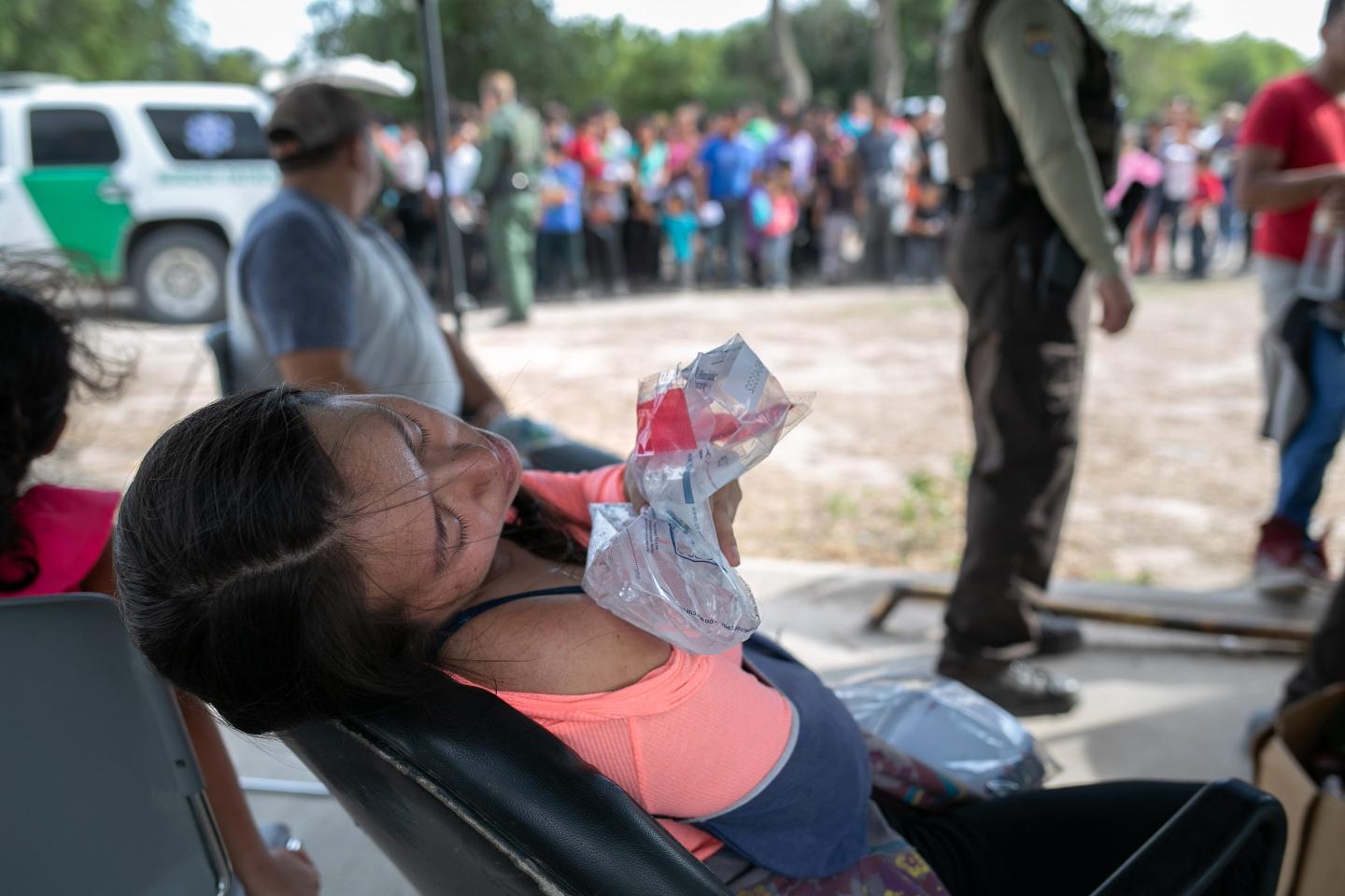 An immigrant from Guatemala ices her shoulder after she was taken into custody by U.S. border agents on July 02, 2019 in Los Ebanos, Texas.