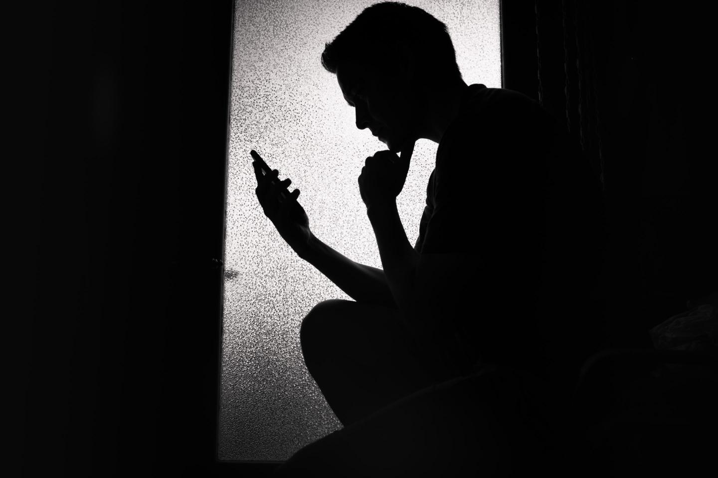 Young man reading using his smart phone