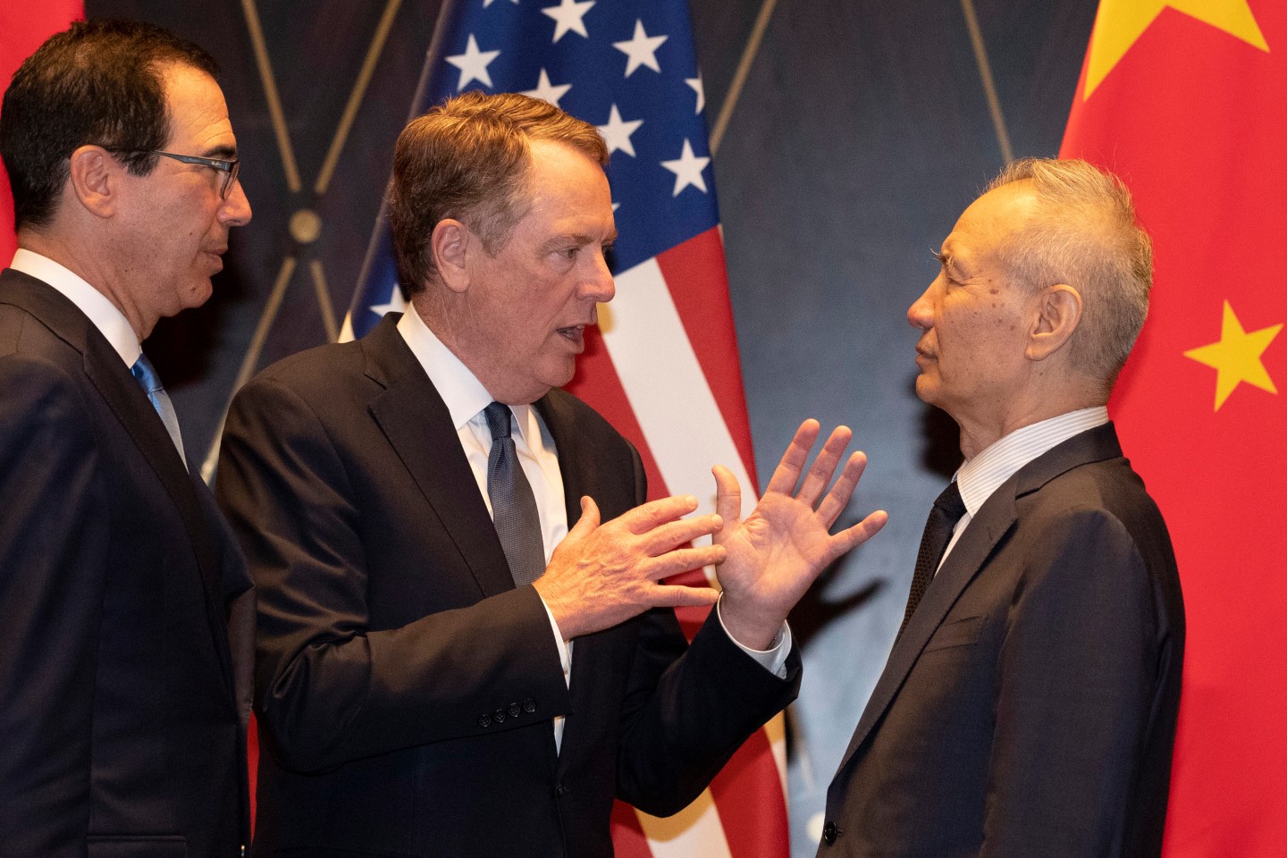 United States Trade Representative Robert Lighthizer (C) gestures as he chats with Chinese Vice Premier Liu He (R) as US Treasury Secretary Steven Mnuchin (L) looks on after posing for a "family photo" at the Xijiao Conference Centre in Shanghai on July 31, 2019. - Chinese and US negotiators held talks in Shanghai on July 31 in a bid to bring an end to a year-long trade war, with the meeting overshadowed by a Twitter tirade from President Donald Trump. (Photo by Ng Han Guan / POOL / AFP) (Photo credit should read NG HAN GUAN/AFP/Getty Images)