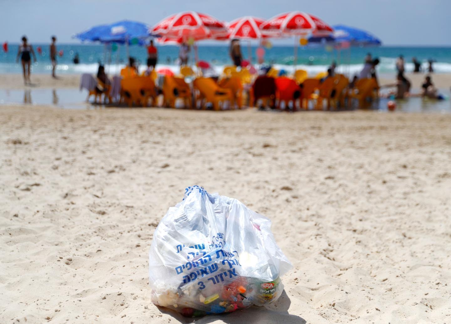 Plastic trash bag on beach