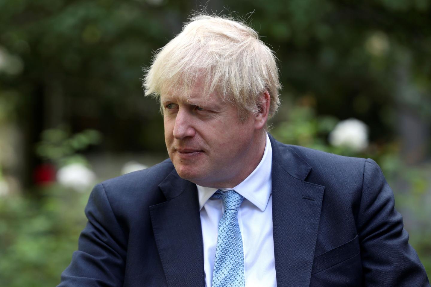 Britain's Prime Minister Boris Johnson looks on as he speaks with British actress Barbara Windsor (not pictured) after she delivers a petition calling for urgent action on dementia care in the garden at 10 Downing Street on September 2, 2019.