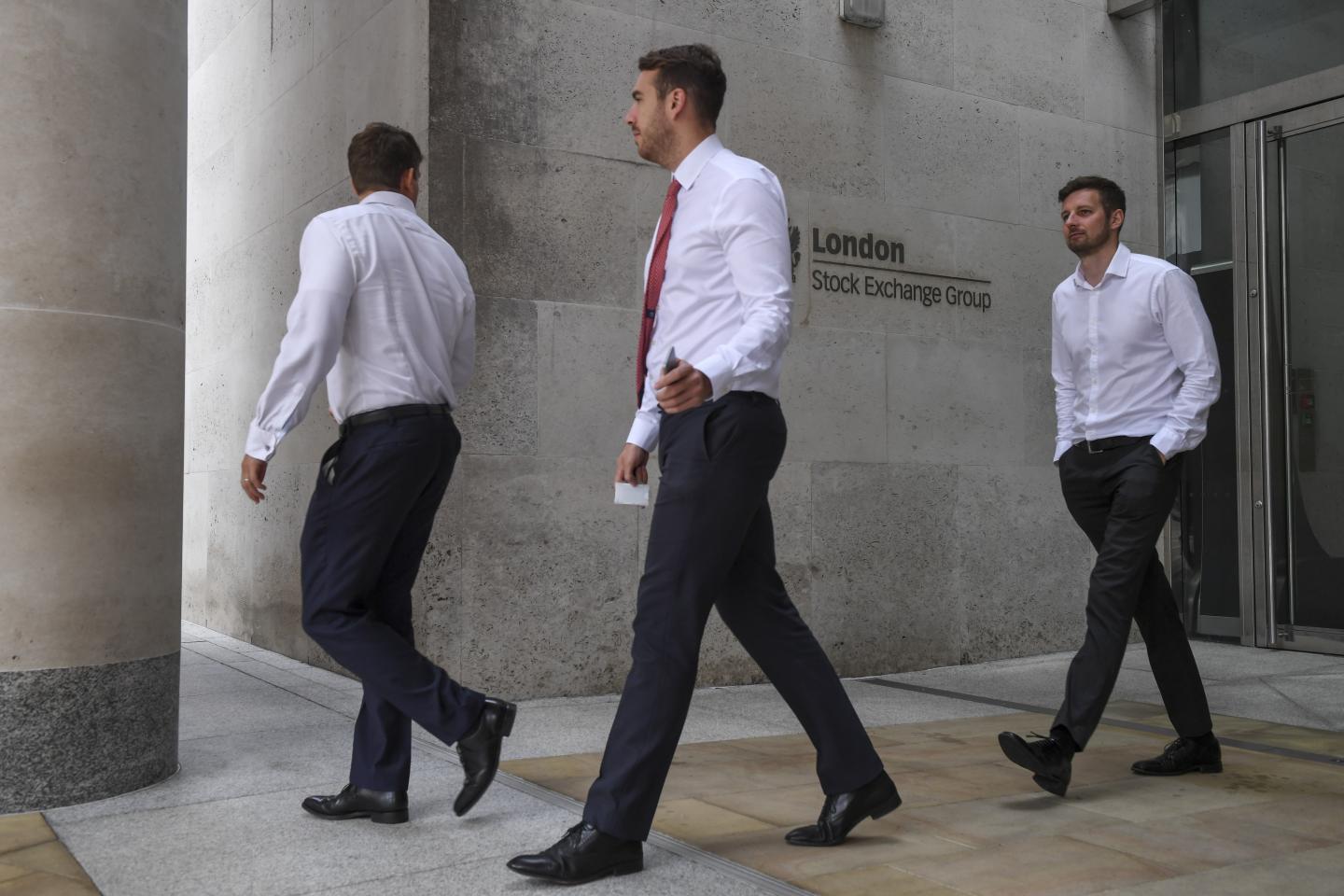 Pedestrians pass a sign at the London Stock Exchange Group Plc headquarter offices in the City of London, U.K., on Wednesday, Sept. 11, 2019. Hong Kong Exchanges and Clearing Ltd. made an unexpected bid for LSE, which could potentially throw the European exchange's own transformative deal into jeopardy. Photographer: Chris J. Ratcliffe/Bloomberg via Getty Images