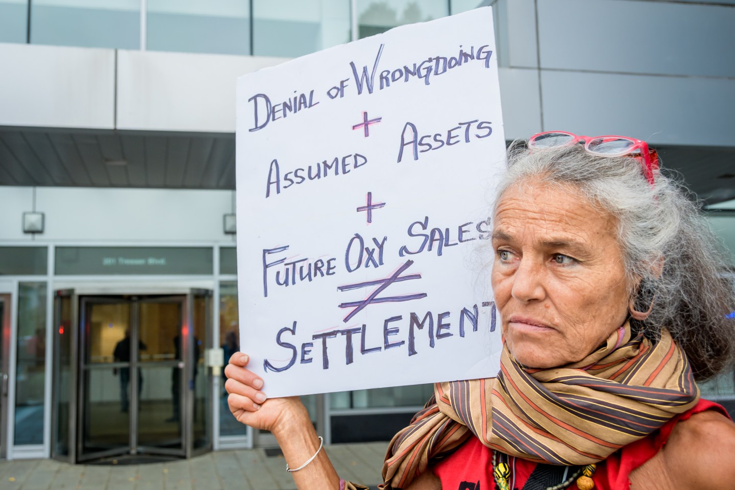 PURDUE PHARMA, STAMFORD, CT, UNITED STATES - 2019/09/12: Members of P.A.I.N. (Prescription Addiction Intervention Now) and Truth Pharm staged a protest on September 12, 2019 outside Purdue Pharma headquarters in Stamford, over their recent controversial opioid settlement. Participants dropped hundreds prescription bottles of OxyContin while holding tombstones with the names of opioids casualties and banners reading "Shame on Sackler" and "200 Dead Each Day". (Photo by Erik McGregor/LightRocket via Getty Images)