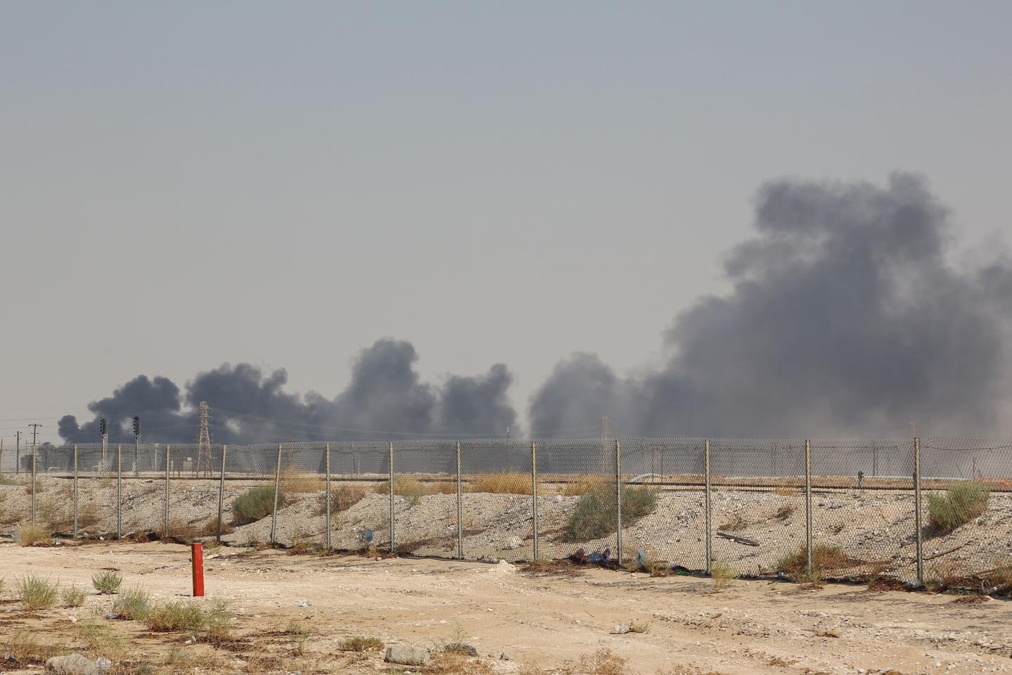 TOPSHOT - Smoke billows from an Aramco oil facility in Abqaiq about 60km (37 miles) southwest of Dhahran in Saudi Arabia's eastern province on September 14, 2019. - Drone attacks sparked fires at two Saudi Aramco oil facilities early today, the interior ministry said, in the latest assault on the state-owned energy giant as it prepares for a much-anticipated stock listing. Yemen's Iran-aligned Huthi rebels claimed the drone attacks, according to the group's Al-Masirah television. (Photo by - / AFP) (Photo credit should read -/AFP/Getty Images)