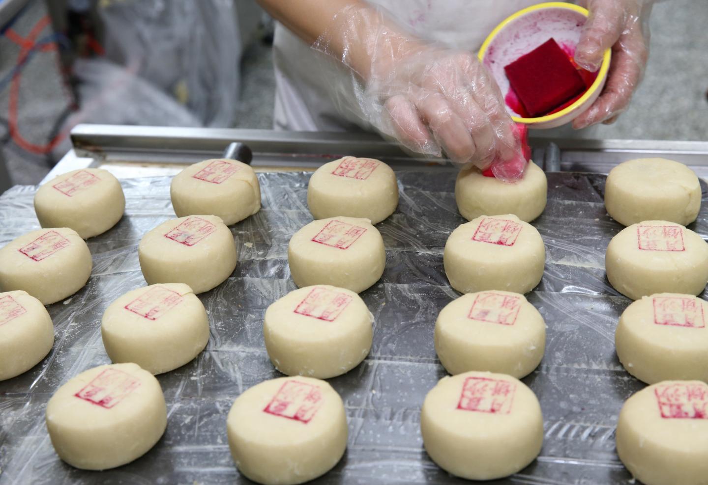 A worker makes mooncakes for the coming Mid-Autumn Festival at a food company on September 1, 2019 in Nantong, Jiangsu Province of China.