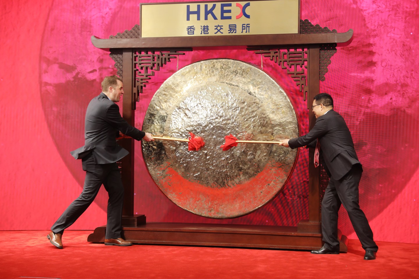 Jan Craps, chief executive officer of Budweiser Brewing Company APAC Ltd., left, and Frank Wang, executive director, general counsel and joint company secretary, strike a gong during the company's listing ceremony at the Hong Kong Stock Exchange in Hong Kong, China, on Monday, Sept. 30, 2019. The Asia-Pacific beer unit of Anheuser-Busch InBev NV gained as much as 4.8% in its Hong Kong trading debut, a positive for the lackluster global market in initial public offerings and vindication for the beermaker in its second attempt at an Asian listing. Photographer: Kyle Lam/Bloomberg via Getty Images