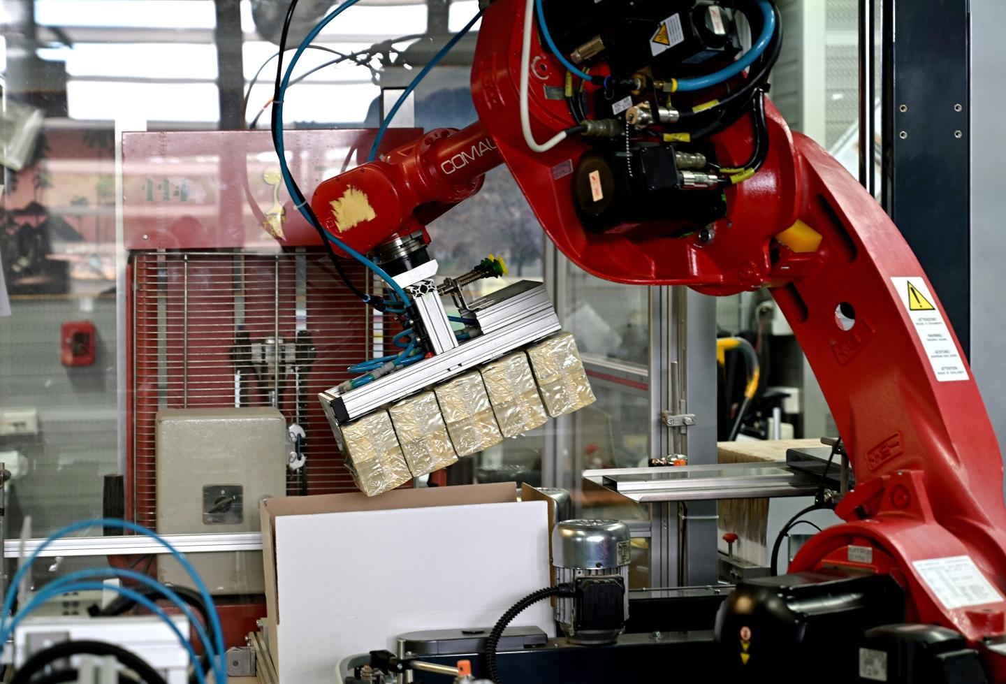 A picture taken on May 20, 2019 shows a robot with pakages of new 200 euro banknotes during the printing procedure at the Bankitalia, the Italian national central bank, high-security factory in Rome. - The ECB allocates production volumes to different national central banks, which then supply a specific proportion of the total annual production. The banknotes are subsequently distributed among the different national central banks. (Photo by Vincenzo PINTO / AFP) (Photo credit should read VINCENZO PINTO/AFP/Getty Images)