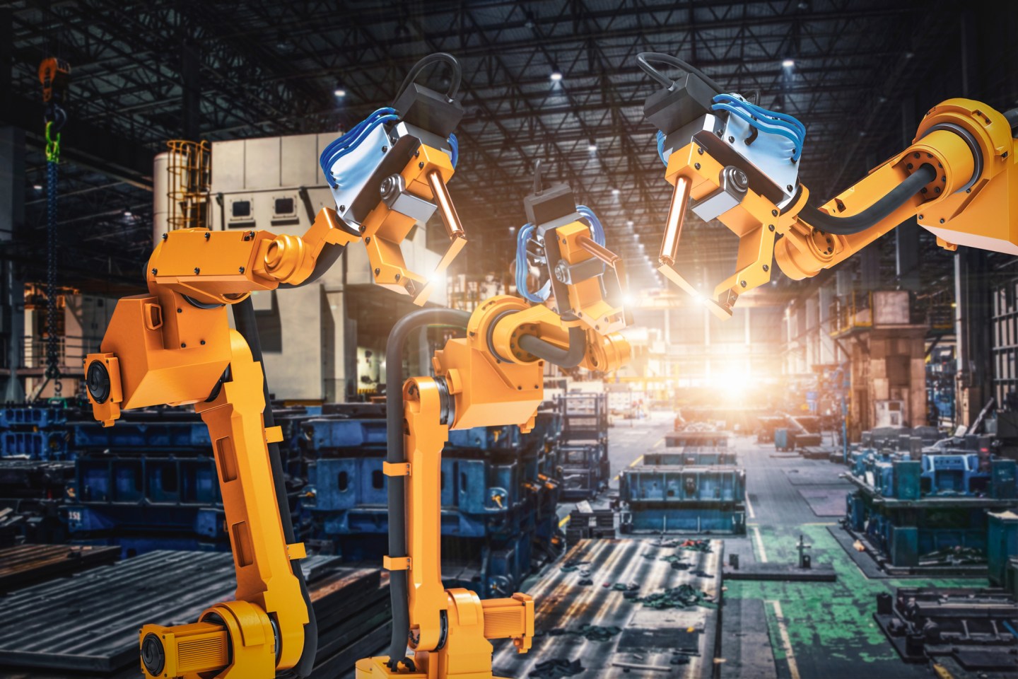 Robot arms in a factory.