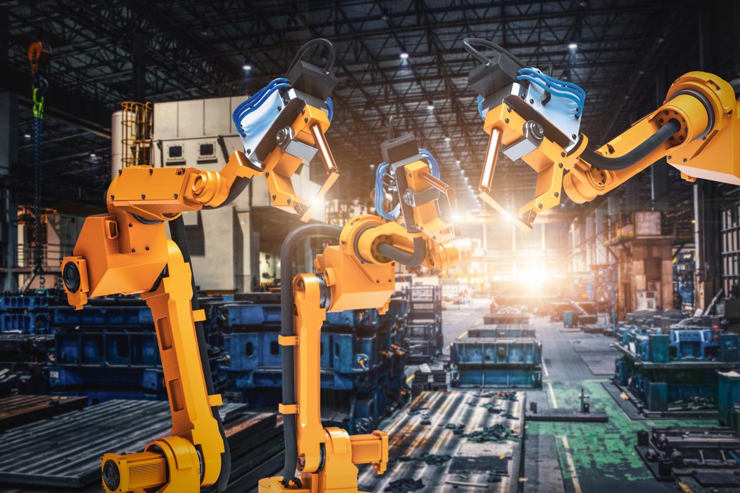 Robot arms in a factory.
