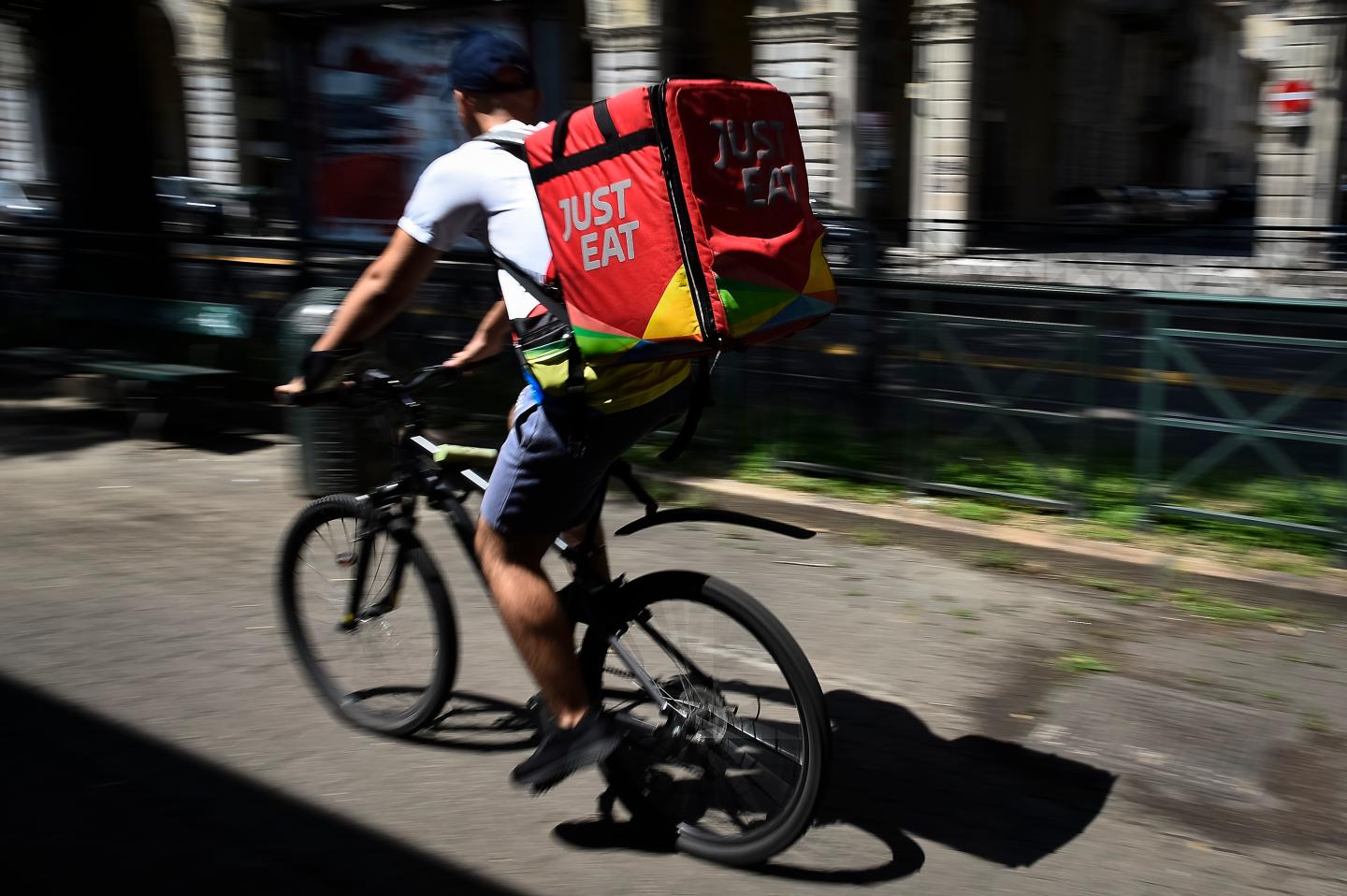 VIA SACCHI, TURIN, ITALY - 2019/08/02: A Just Eat courier rides during his work. Just Eat is a online food delivery app (as Glovo, Uber Eats and Foodora) that hires food riders as independent contractors. (Photo by Nicolò Campo/LightRocket via Getty Images)