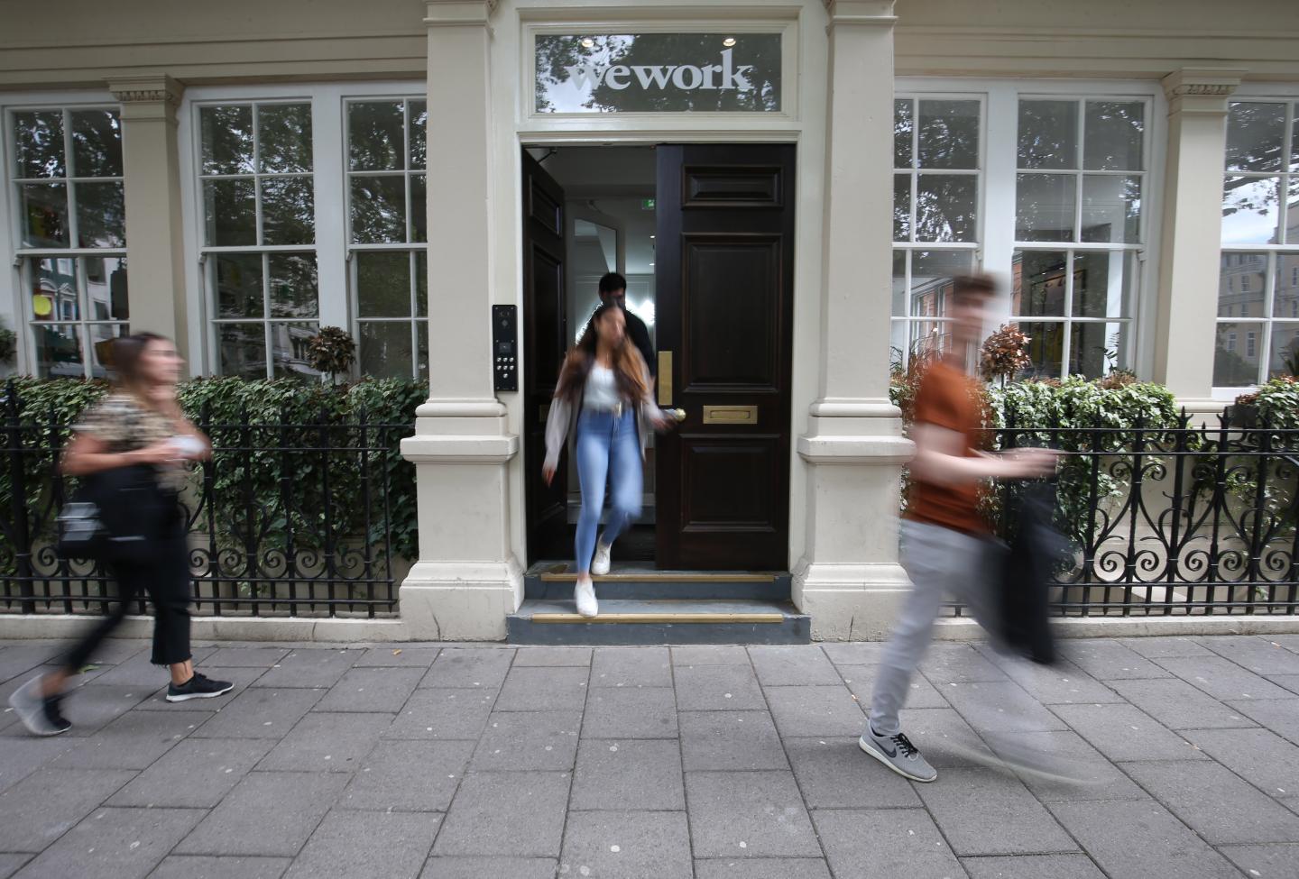 Signage outside the co-working office space group, WeWork, at Soho Square,London. (Photo by Jonathan Brady/PA Images via Getty Images)