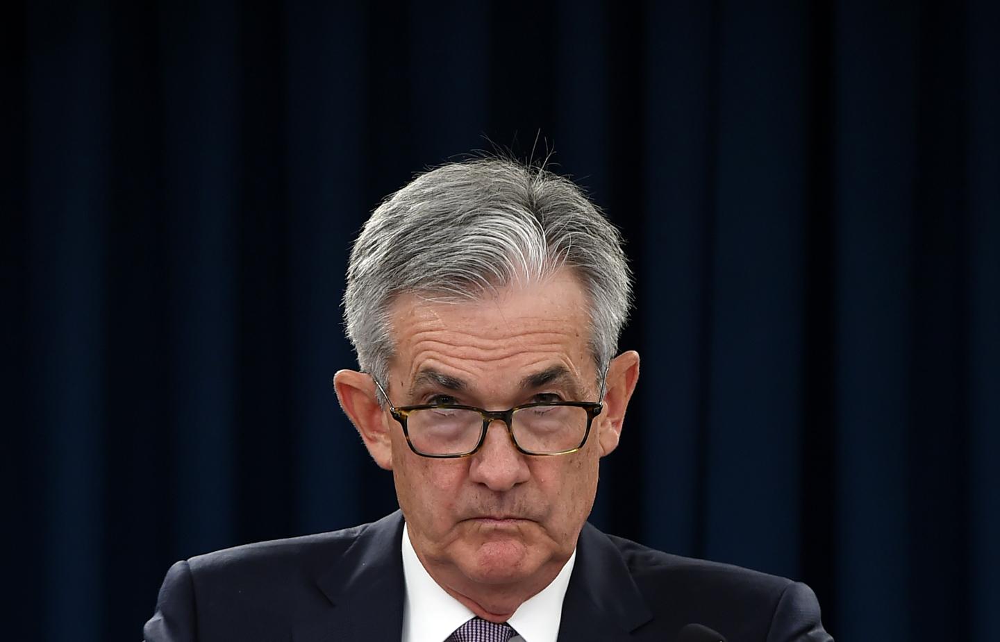 Jerome Powell looks over his glasses at the camera.