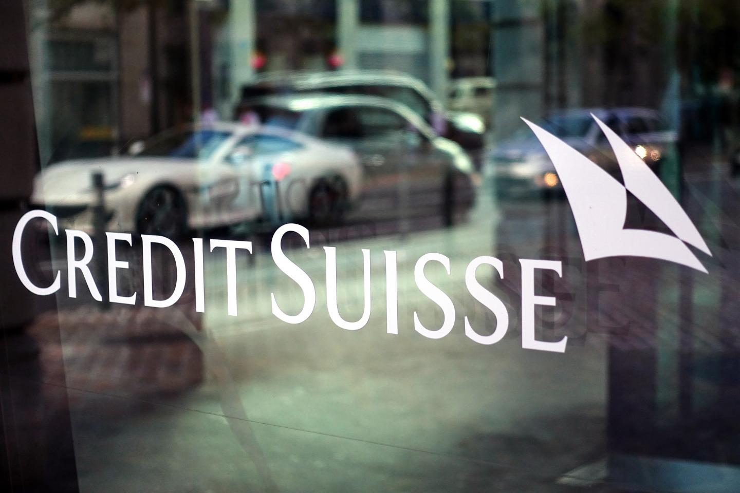 A Credit Suisse logo is displayed on the window of a Credit Suisse Group AG bank branch in Zurich, Switzerland, on Sunday, Sept 29, 2019. Credit Suisse is seeking to draw a line under one of the worst scandals in its recent history after the bank hired a private detective agency to shadow former executive Iqbal Khan because of fears hed poach employees after moving to UBS Group AG. Photographer: Stephen Kelly/Bloomberg via Getty Images