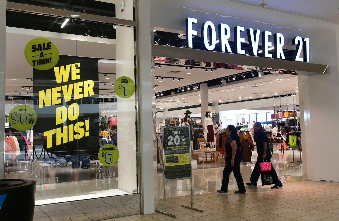 People enter a Forever 21 store at a shopping mall in Montebello, California on September 30, 2019 a day after the fashion retailer filed for Chapter 11 bankruptcy protection.
