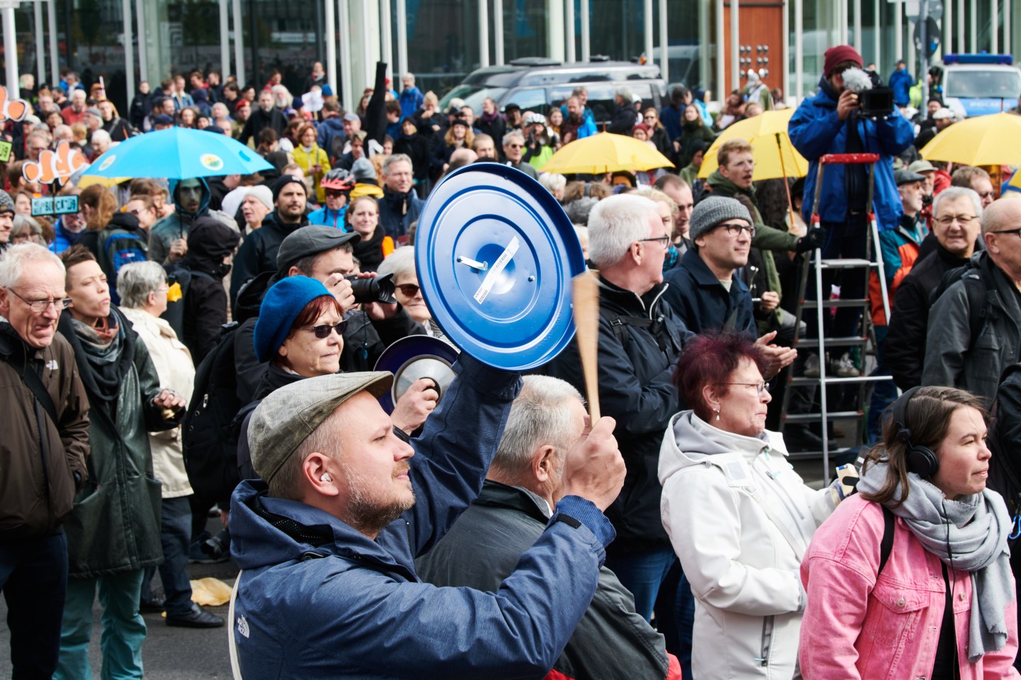03 October 2019, Berlin: A demonstrator generates noise by hitting a cooking pot lid with a cooking spoon. Several thousand people came to the demonstration against rising rents. Photo: Annette Riedl/dpa (Photo by Annette Riedl/picture alliance via Getty Images)