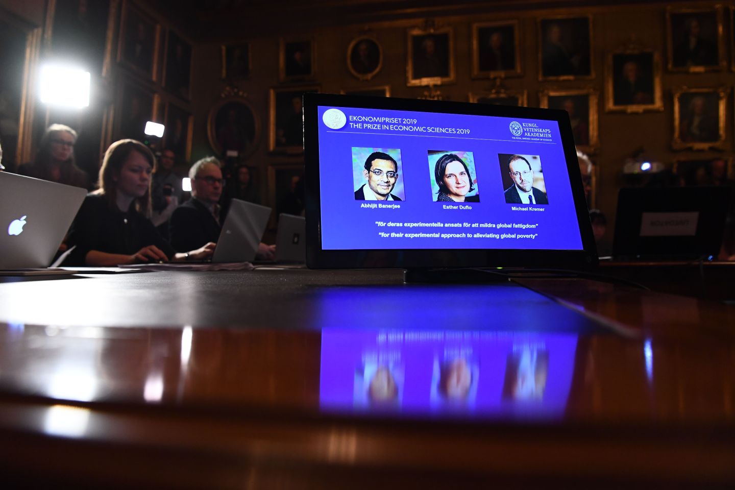 A computer screen displays the portraits of the laureates of the 2019 Nobel Prize for Economic Sciences (L-R) Indian-born Abhijit Banerjee of the US, French-American Esther Duflo and Michael Kremer of the US during the announcement of the winners of the 2019 Nobel Prize in Economic Sciences at the Royal Swedish Academy of Sciences on October 14, 2019 in Stockholm. - Indian-born Abhijit Banerjee of the US, French-American Esther Duflo and Michael Kremer of the US won the Nobel Economics Prize for their "experimental approach to alleviating global poverty", the Royal Swedish Academy of Sciences said. (Photo by Jonathan NACKSTRAND / AFP) (Photo by JONATHAN NACKSTRAND/AFP via Getty Images)