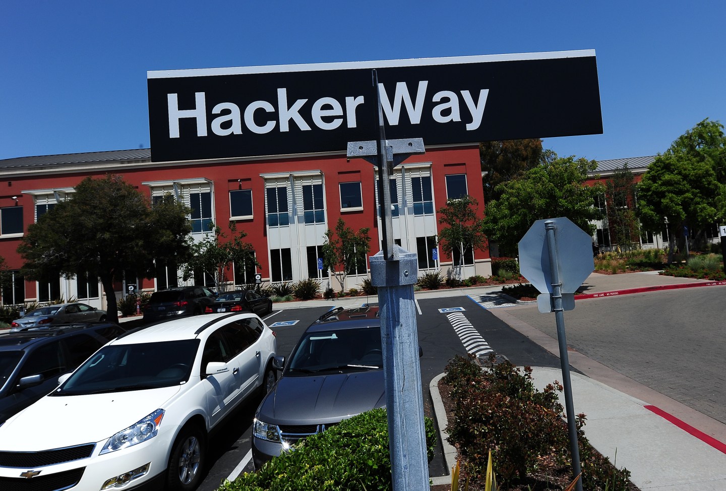 A street sign reading "Hacker Way" is seen in the parking lot of the Facebook headquarters in Menlo Park, California, May 15, 2012. Facebook, the world's most popular internet social network, expects to raise USD 12.1 billion in what will be Silicon Valley's largest-ever initial public offering (IPO) later this week. AFP PHOTO / ROBYN BECK (Photo credit should read ROBYN BECK/AFP/GettyImages)