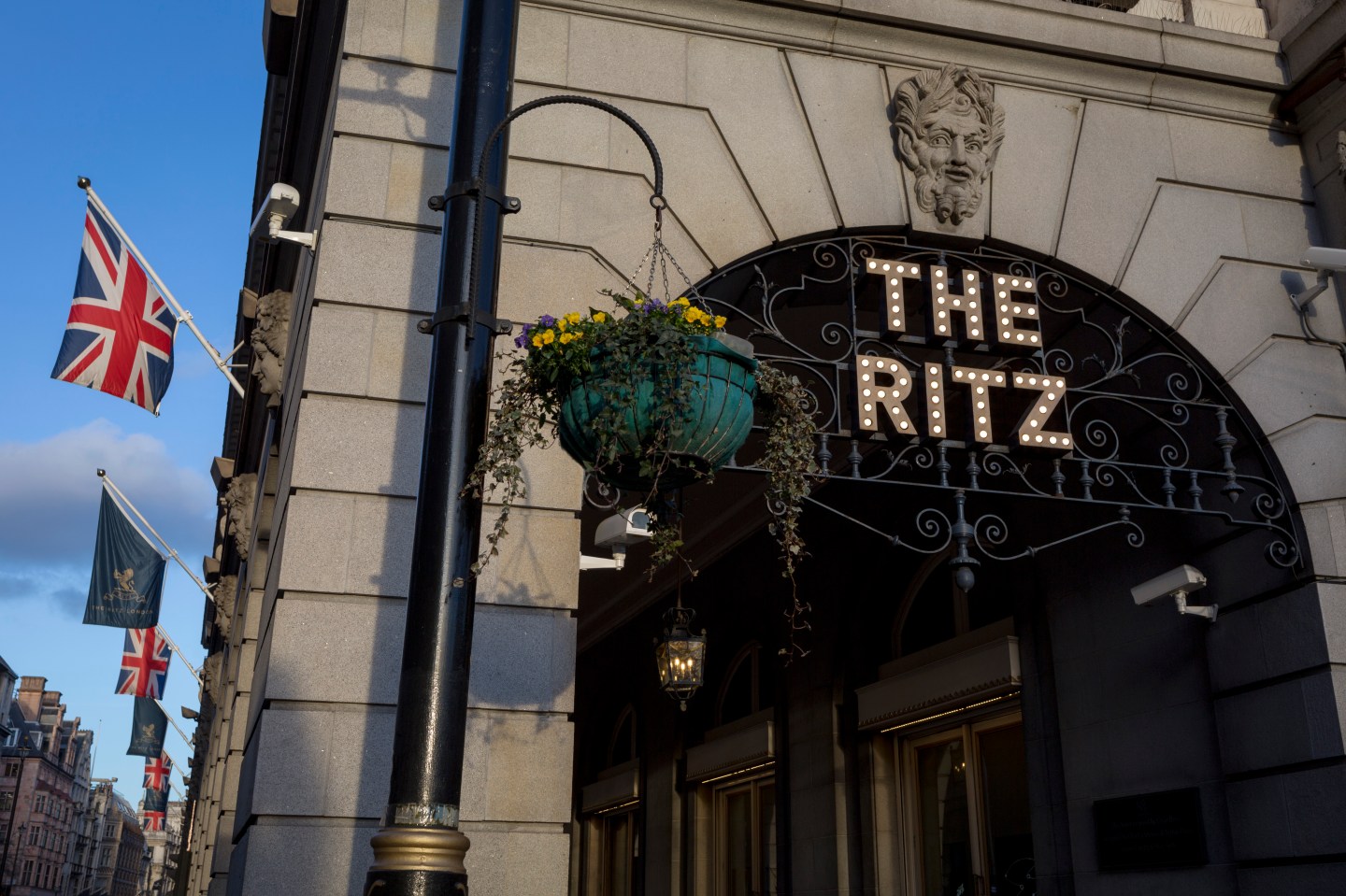The entrance of the arcade outside The Ritz with Union Jack flags and distant architecture on Piccadilly, on 7th February 2018, in London, England.