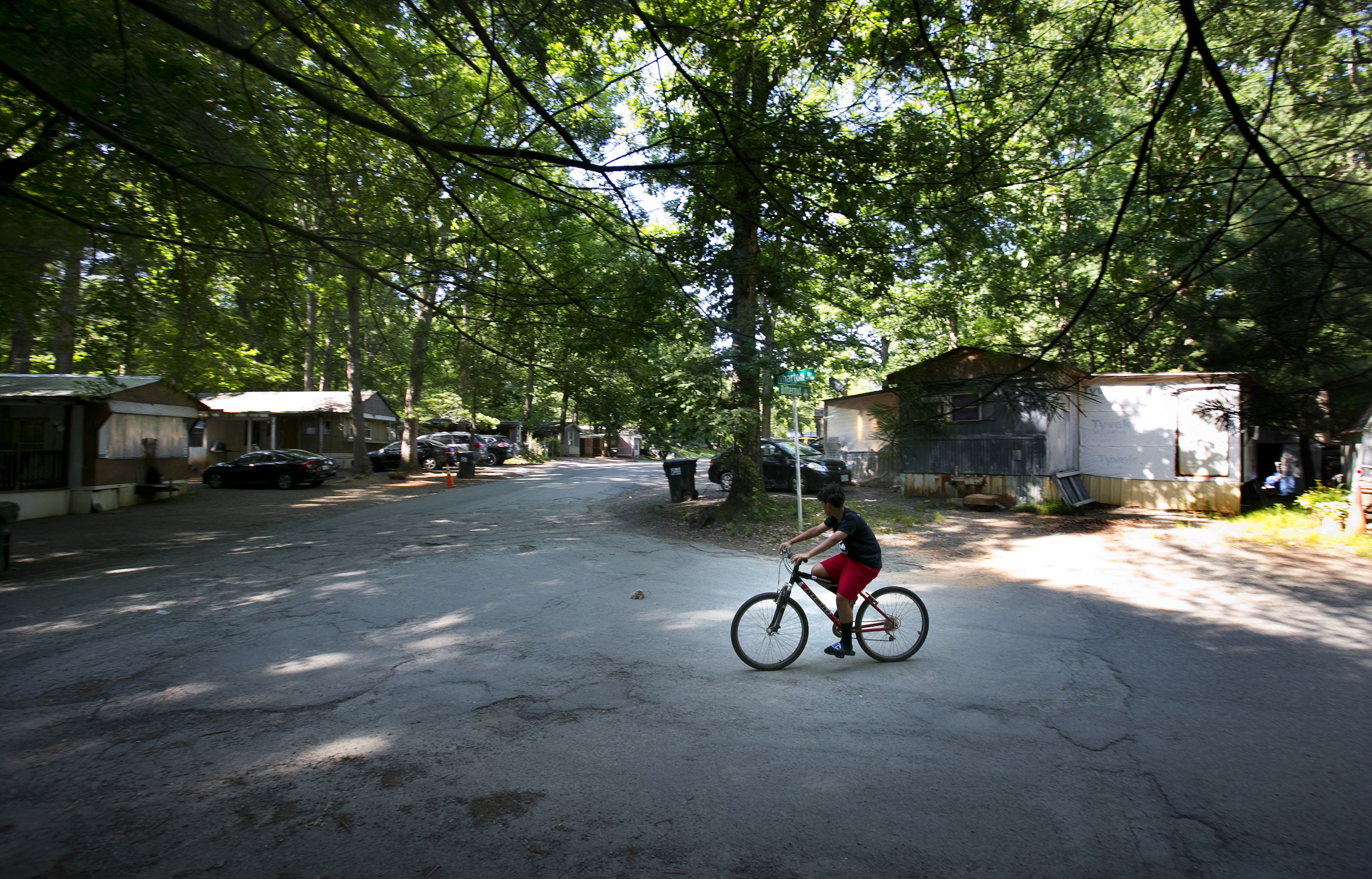 boy rides his bike Monday, June 3, 2019 in the Southwood Mobile Home Park in Charlottesville, Virginia.