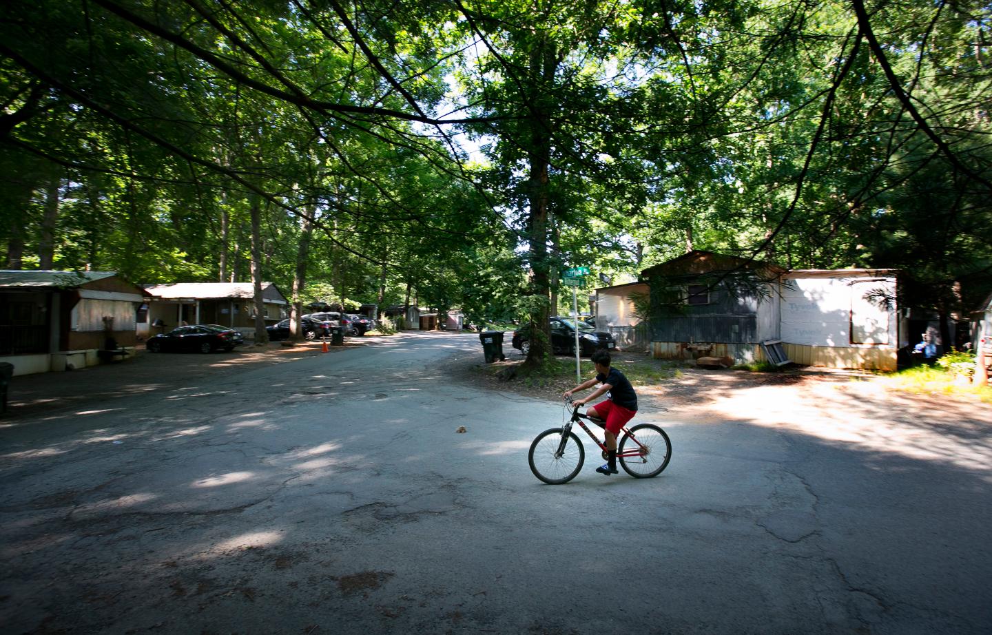 boy rides his bike Monday, June 3, 2019 in the Southwood Mobile Home Park in Charlottesville, Virginia.