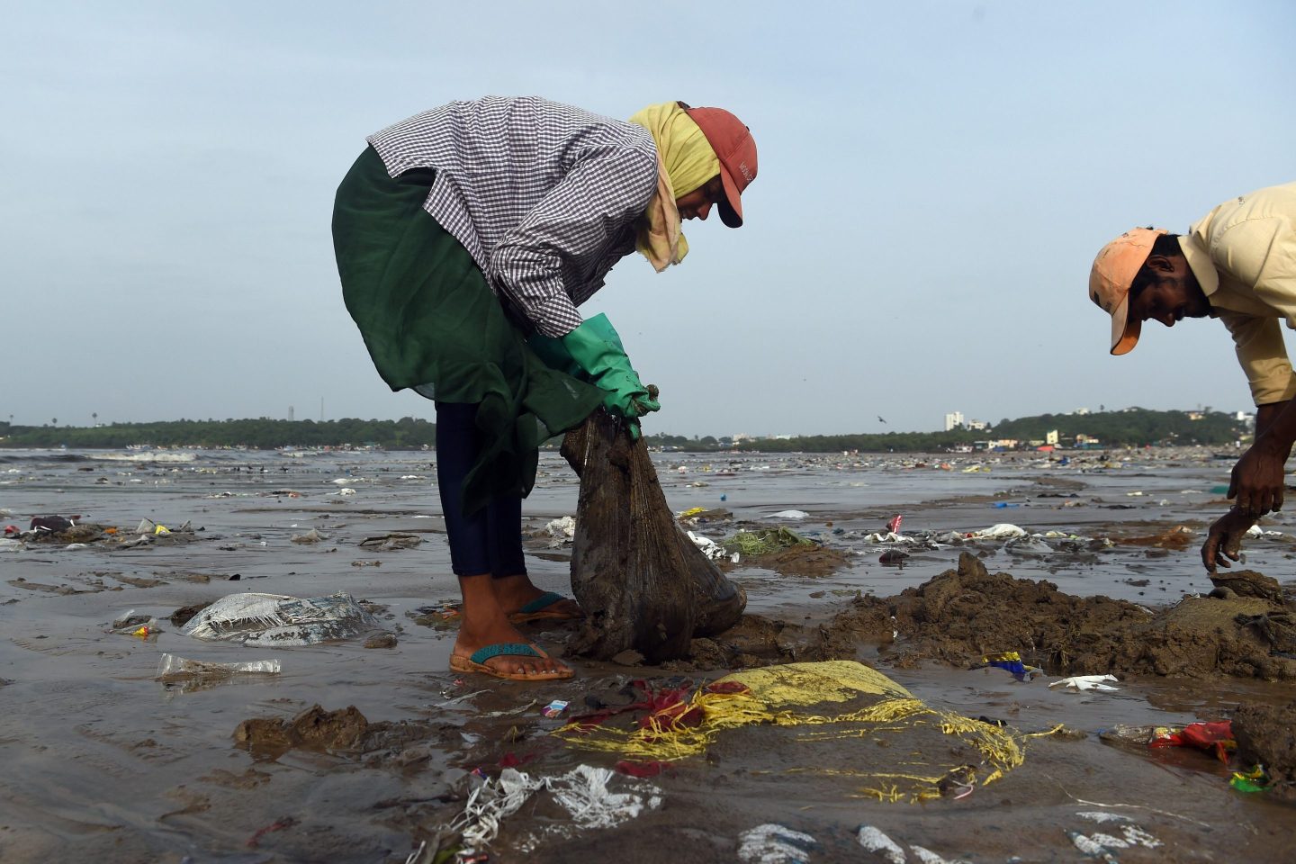 City civil authority workers pick up plastic waste during a clean up drive led by lawyer and environmentalist Afroz Shah (not pictured) at the Versova beach in Mumbai on September 14, 2019.