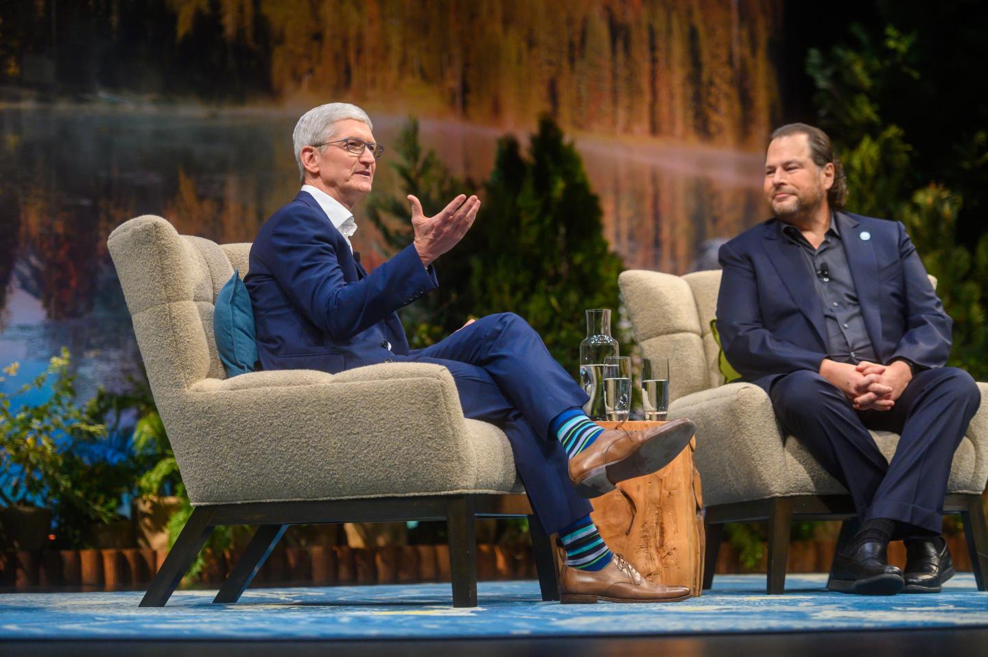 Apple CEO Tim Cook talks to Salesforce CEO Marc Benioff