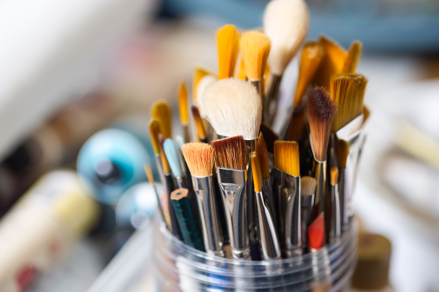 A jar of clean paintbrushes, with bristles pointed up.