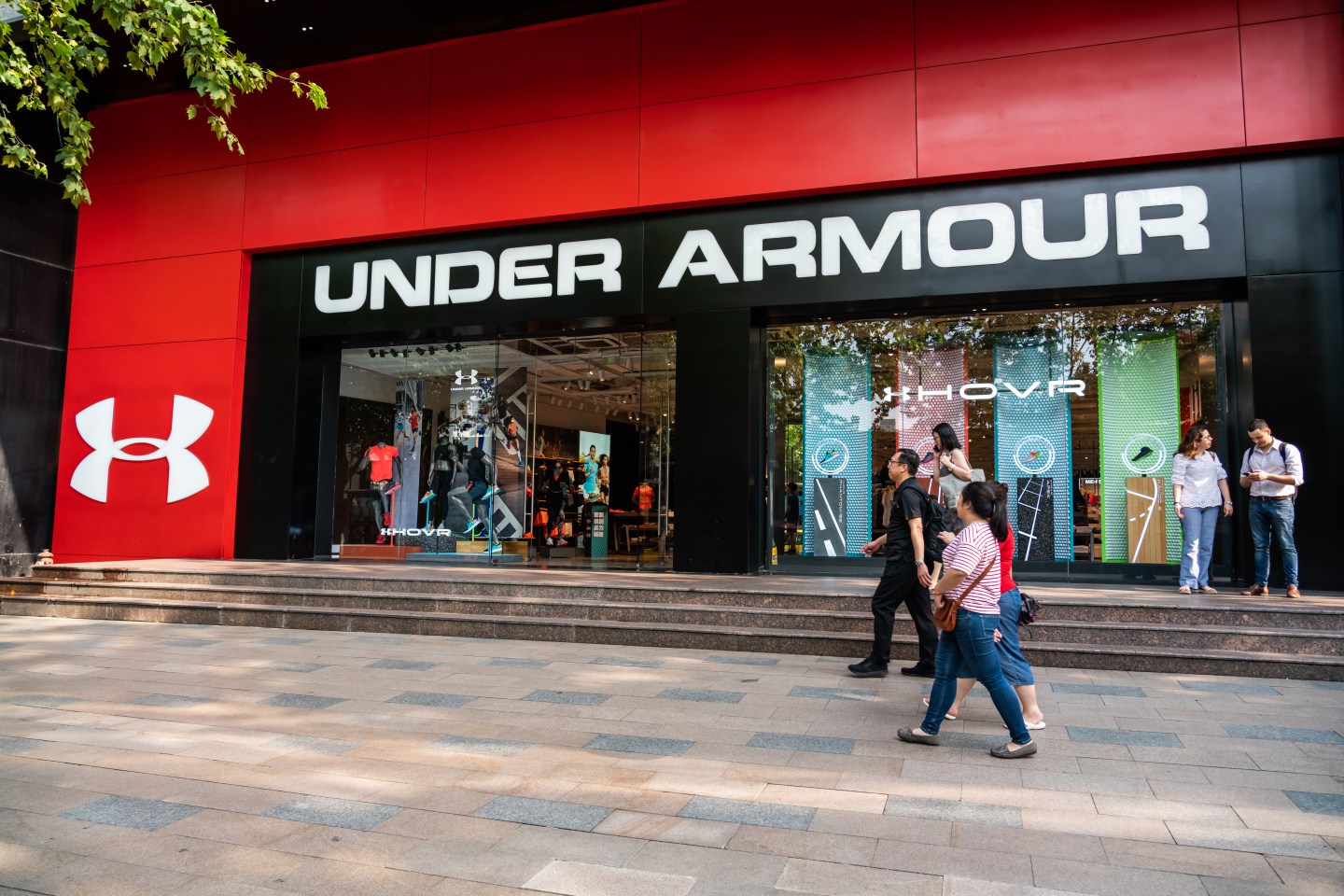 SHANGHAI, CHINA - 2019/09/07: Pedestrians walk past an American sportswear manufacturer Under Armour store in Shanghai. (Photo by Alex Tai/SOPA Images/LightRocket via Getty Images)