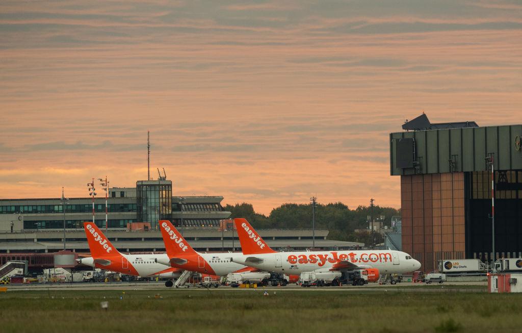 Three Easyjet aircraft are parked on the tarmac of Berlin-Tegel Airport.