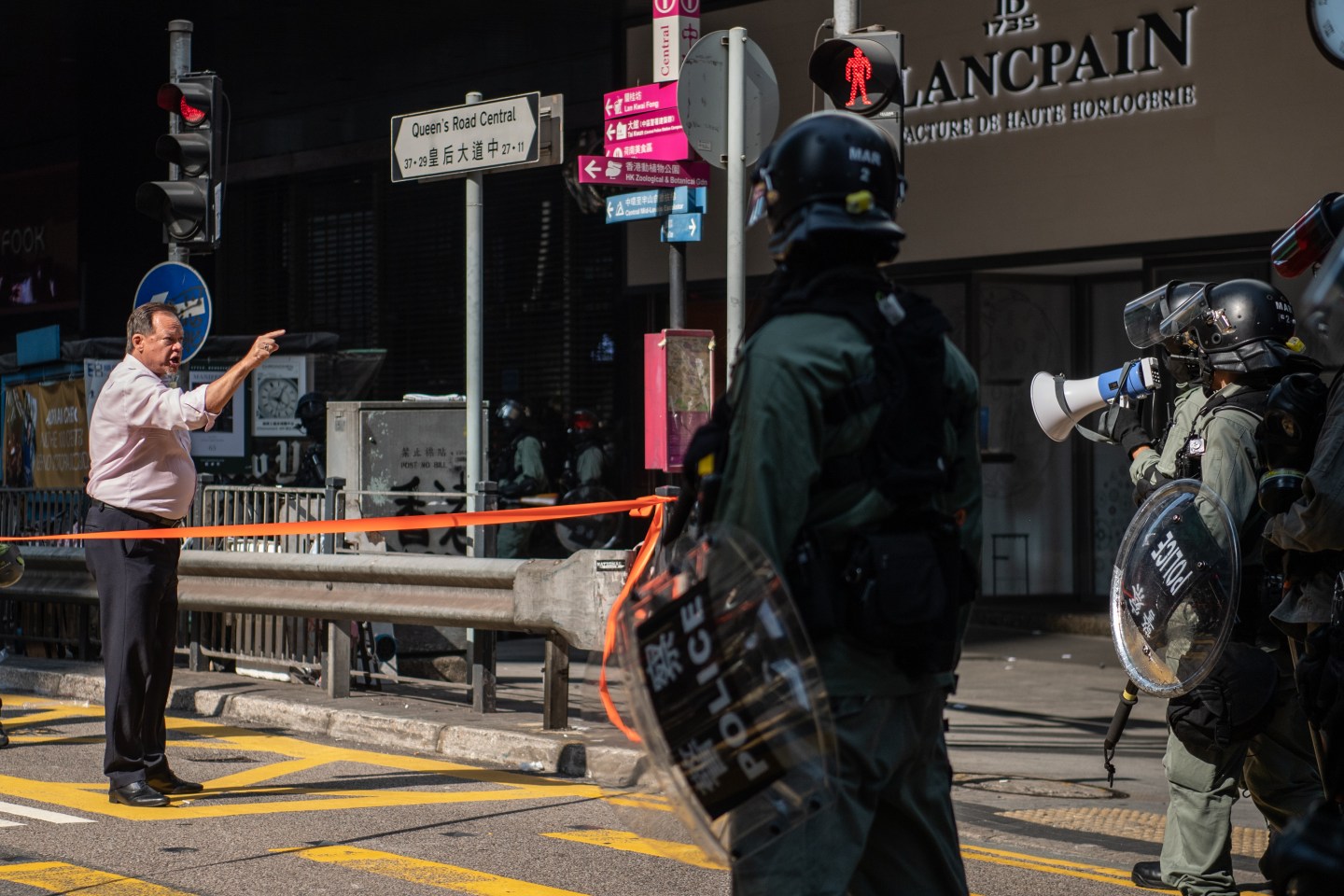A man yells at riot police during a protest in the Central district of Hong Kong, China, on Wednesday, Nov. 13, 2019. Hong Kong officials and Chinese state media warned of consequences if violence continued, as a third-straight day of protests disrupted traffic across the city and the government announced for the first time that it would close public schools. Photographer: Laurel Chor/Bloomberg via Getty Images