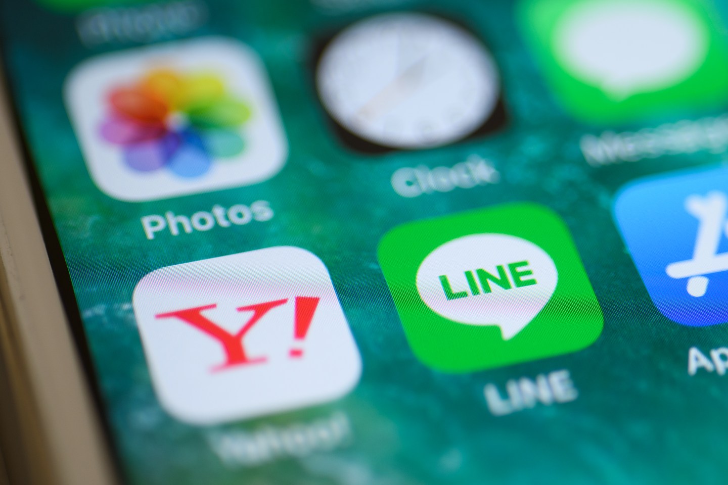 The icons for Z Holdings Corp. Yahoo Japan application, front row from left, and the Line Corp. Line application are displayed on a smartphone in this arranged photograph taken in Kawasaki, Kanagawa Prefecture, Japan, on Thursday, Nov. 14, 2019. Z Holdings, a unit of SoftBank Group Corp.s telecom arm formerly known as Yahoo Japan, confirmed that its in talks with Tokyo-based messaging service Line about a possible merger, but said no final decision on a deal had been made. Photographer: Akio Kon/Bloomberg via Getty Images