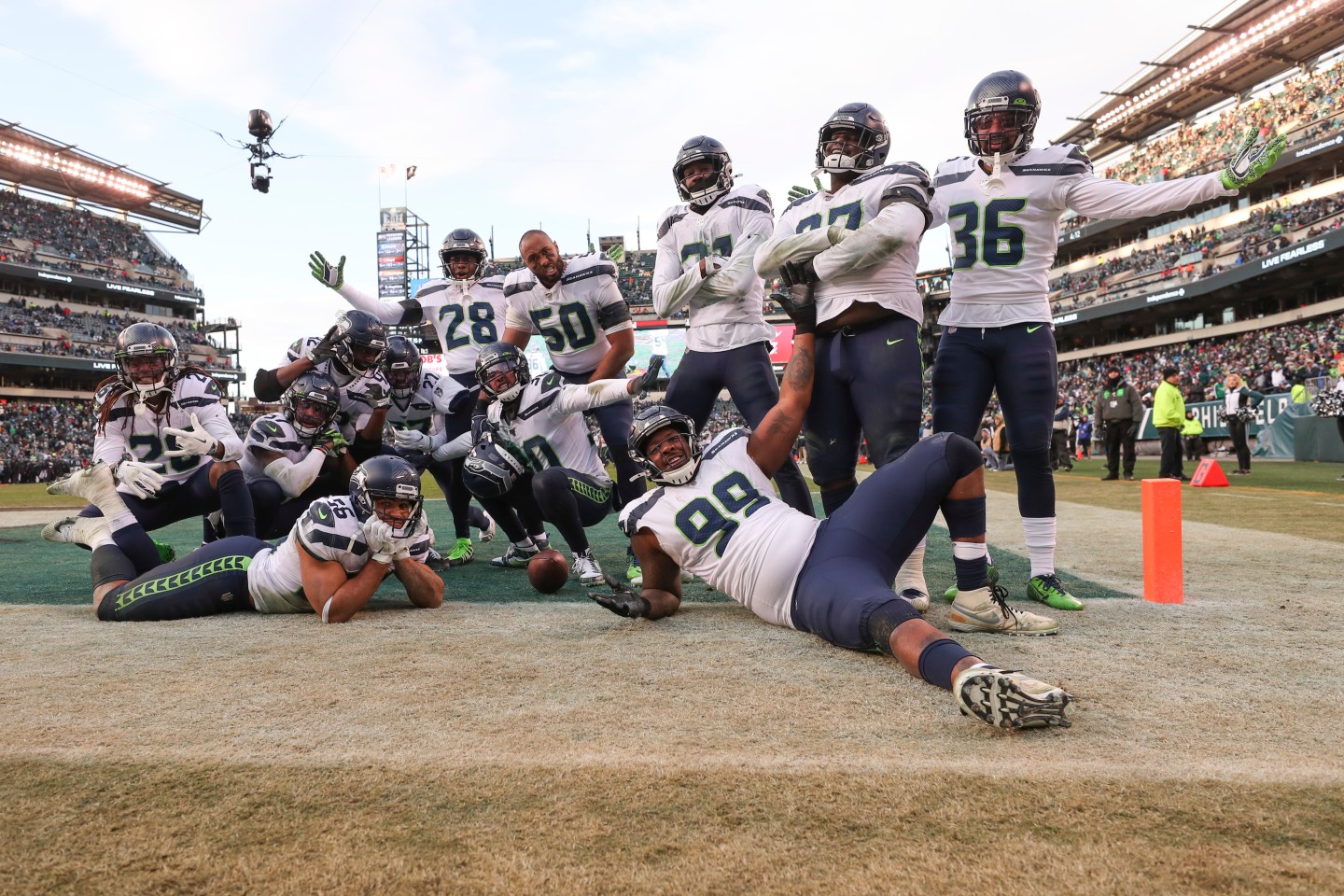 A group of Seattle Seahawks players pose in the endzone
