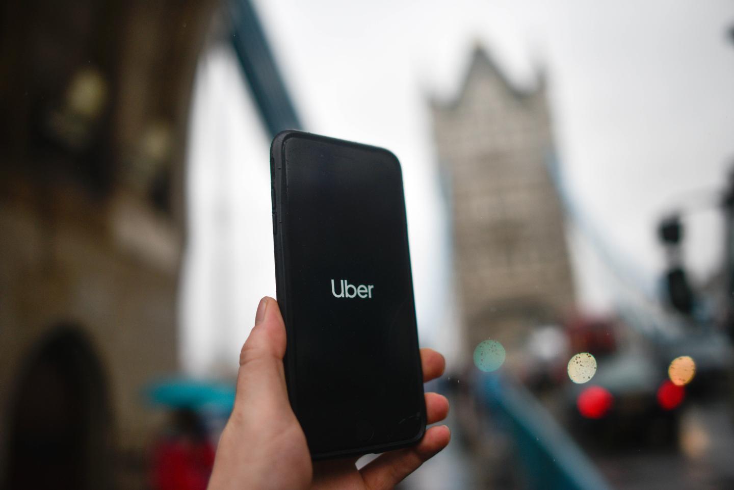 LONDON, ENGLAND - NOVEMBER 25: In this photo illustration the Uber logo is displayed on a phone in front of Tower Bridge on November 25, 2019 in London, England. Transport for London announced today, Monday, that Uber's license won't be renewed after it expires at the end of this month, November. Uber announced that they will appeal the decision. (Photo by Peter Summers/Getty Images)