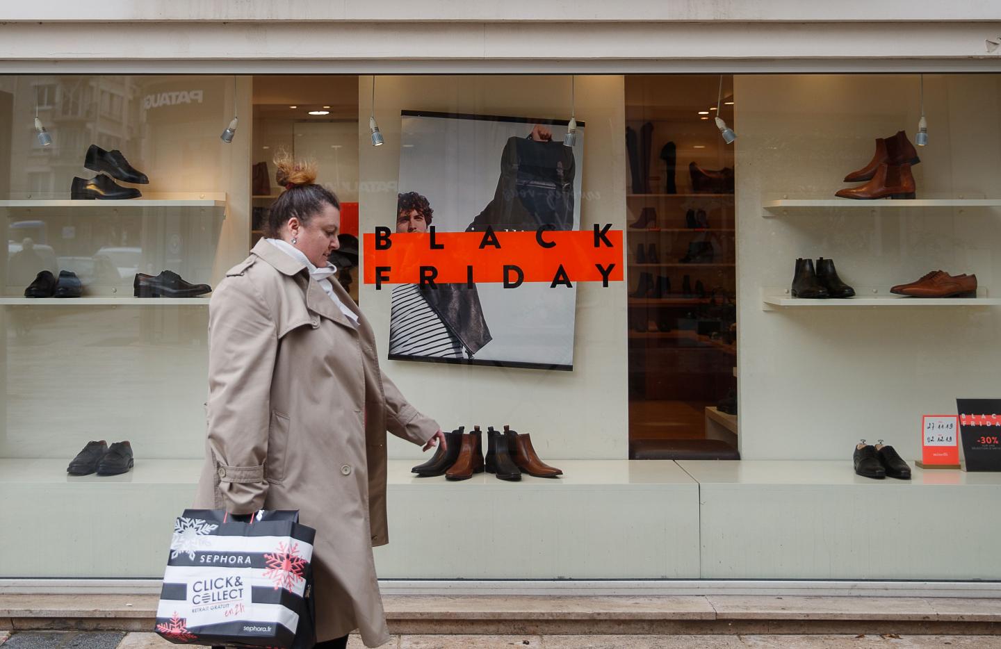 A pedestrian waks past a sign for "Black Friday" sales at a shop in Caen, northwestern France, on November 27, 2019. - Black Friday is a sales offer originating from the US where retailers slash prices on the day after the Thanksgiving holiday. (Photo by Sameer Al-DOUMY / AFP) (Photo by SAMEER AL-DOUMY/AFP via Getty Images)