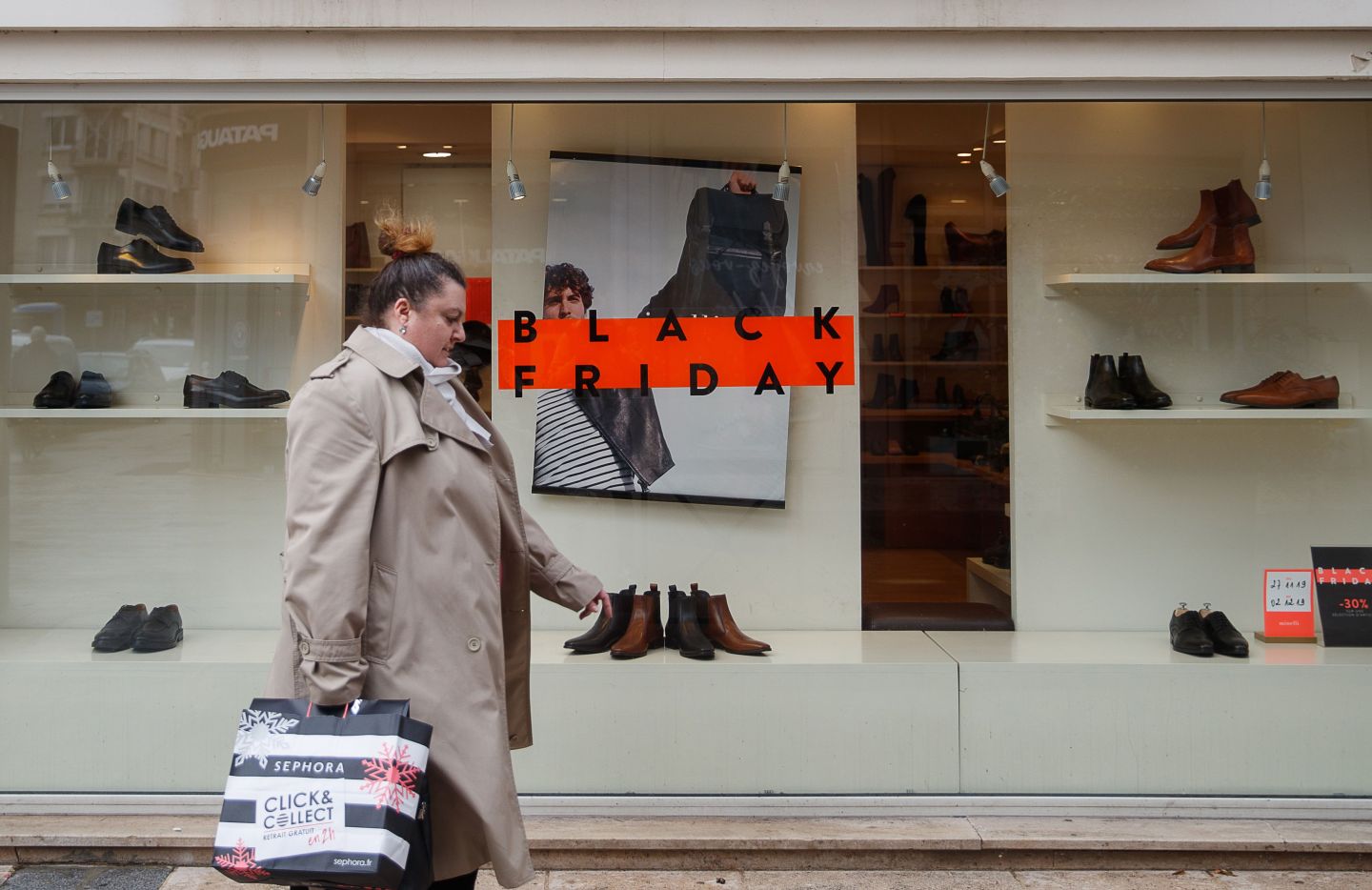 A pedestrian waks past a sign for "Black Friday" sales at a shop in Caen, northwestern France, on November 27, 2019. - Black Friday is a sales offer originating from the US where retailers slash prices on the day after the Thanksgiving holiday. (Photo by Sameer Al-DOUMY / AFP) (Photo by SAMEER AL-DOUMY/AFP via Getty Images)