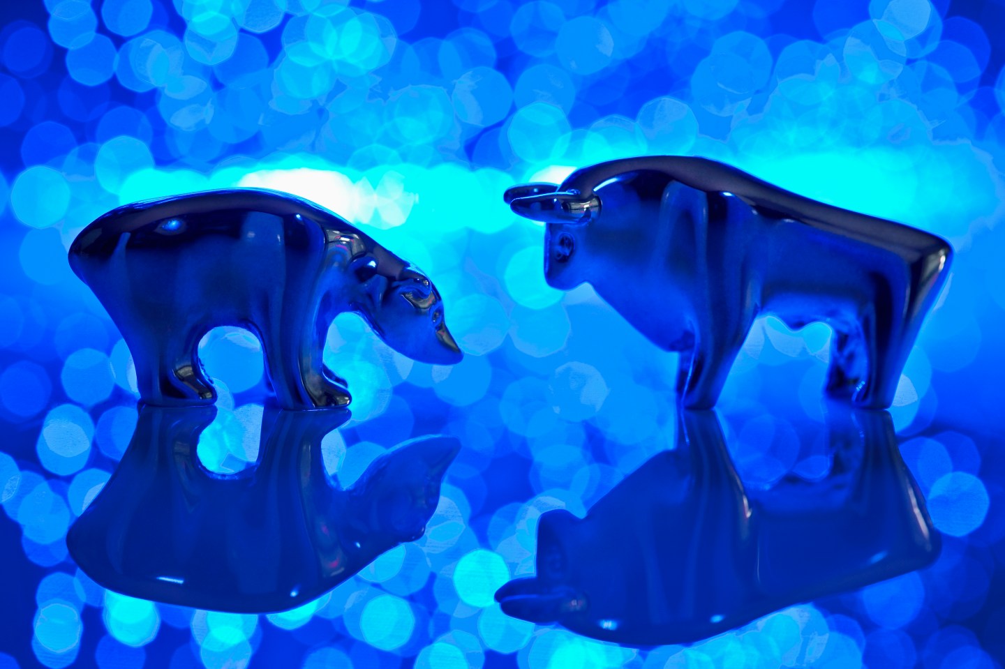 Close up of bear and bull figurine with blue fiber lights