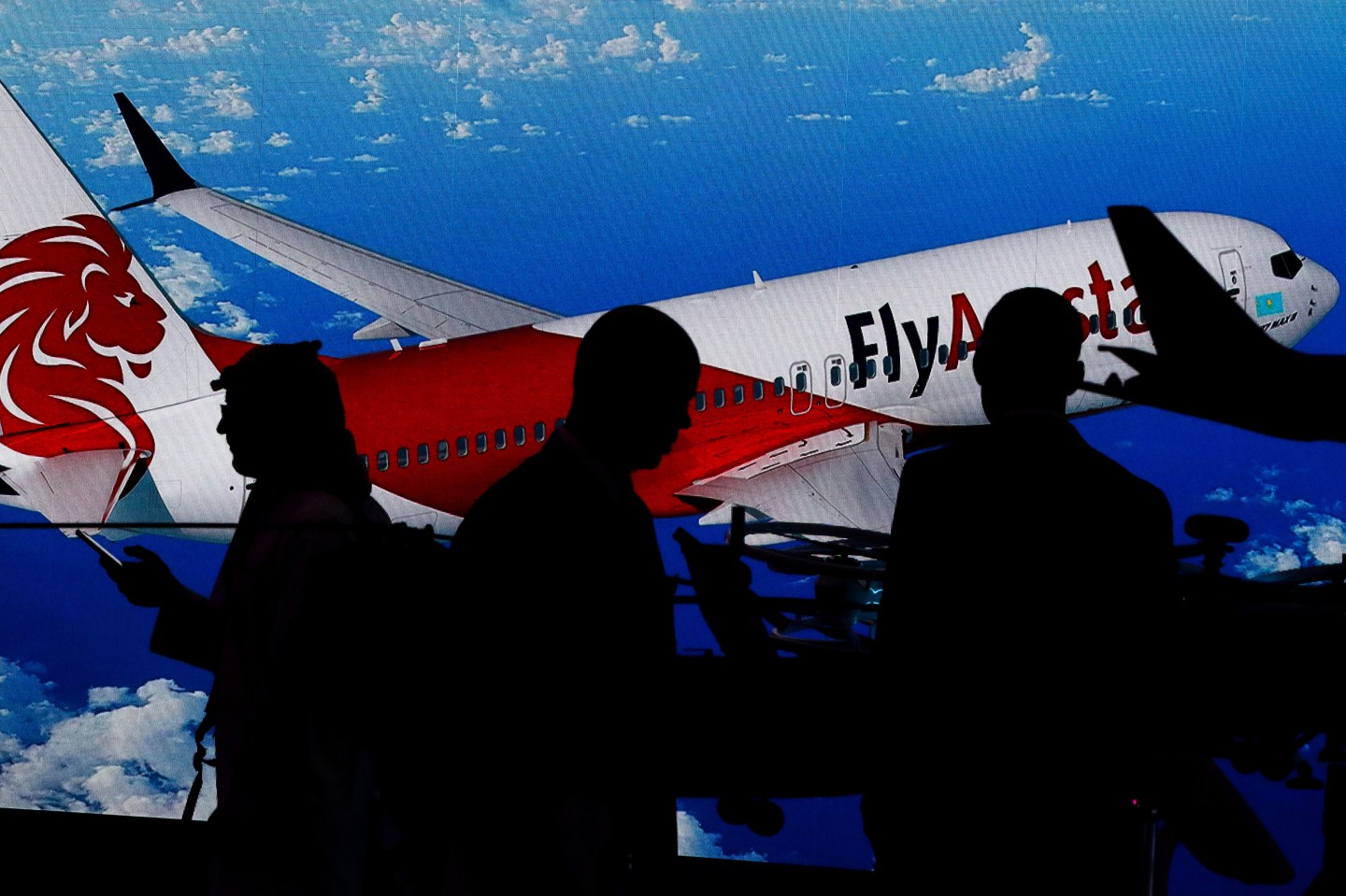 DUBAI, UNITED ARAB EMIRATES - 2019/11/19: Visitors stand next to the image of a Kazakh low cost airline Fly Airstan's Boeing-737 MAX 8, during the third day of the Dubai International Airshow-2019. (Photo by Leonid Faerberg/SOPA Images/LightRocket via Getty Images)