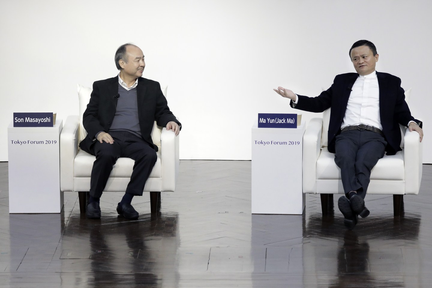 Jack Ma, former chairman of Alibaba Group Holding Ltd., right, gestures while speaking with Masayoshi Son, chairman and chief executive officer of SoftBank Group Corp., at Tokyo Forum 2019 in Tokyo, Japan, on Friday, Dec. 6, 2019. Son unveiled a $184 million initiative Friday to accelerate artificial intelligence research in Japan, enlisting Ma to expound on his goal of commercializing the technology. Son's company announced a partnership with the University of Tokyo that includes spending 20 billion yen ($184 million) over 10 years by mobile arm SoftBank Corp. to establish the Beyond AI Institute. Photographer: Kiyoshi Ota/Bloomberg via Getty Images
